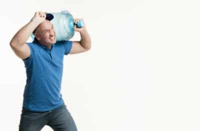 hard working delivery man holding water bottle